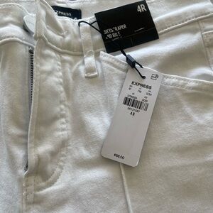 Express skyscraper mid rise, white jeans.